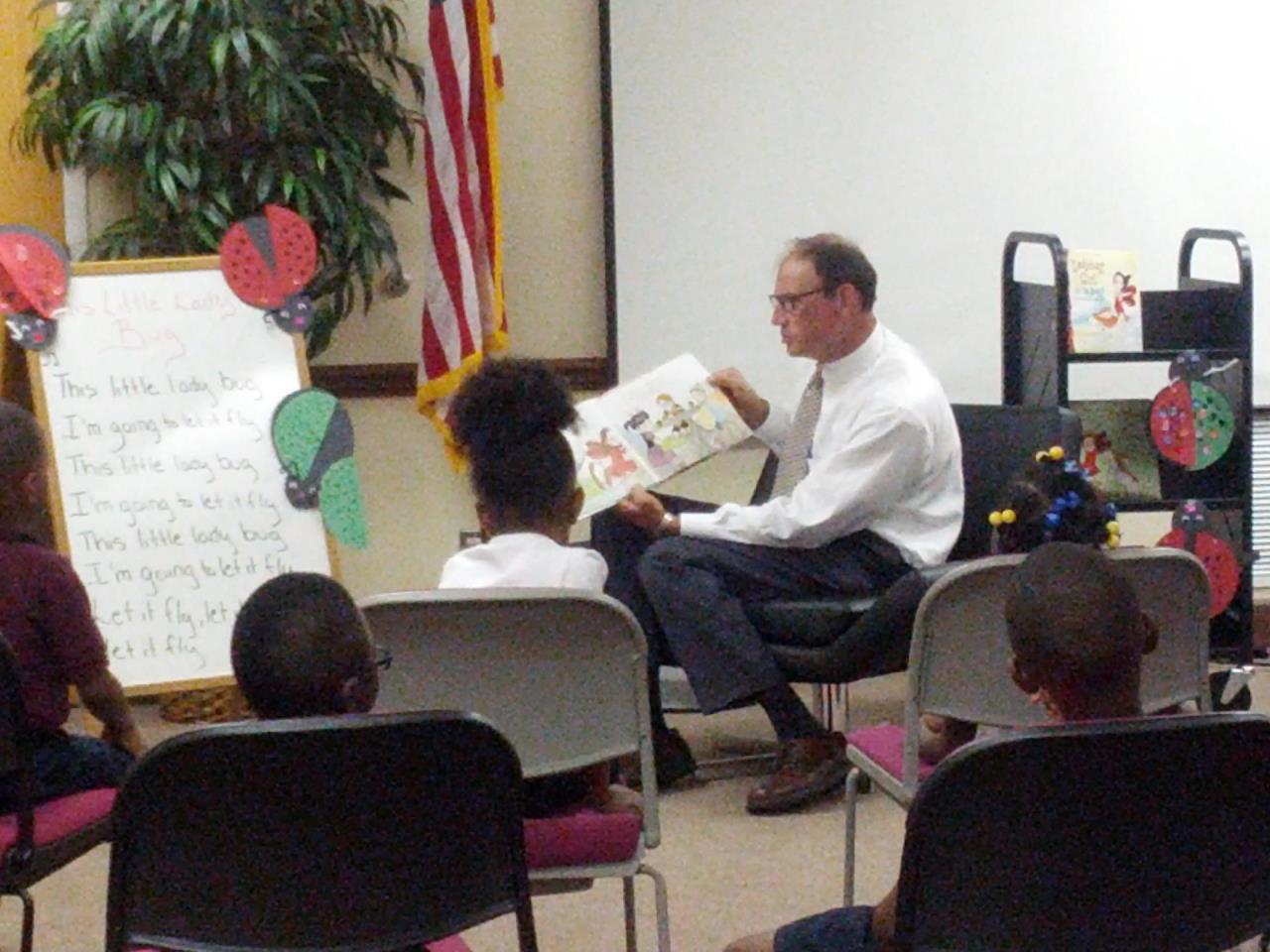 Mayor and Town Manager reads "LadyBug Girl & the Bug Squad" to the children